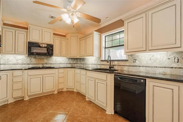 a kitchen with stainless steel appliances granite countertop a sink a stove and cabinets