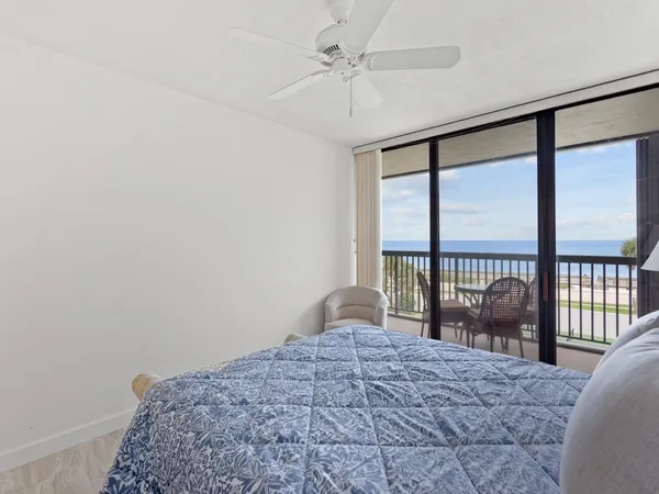 a bathroom with a granite countertop toilet sink and mirror