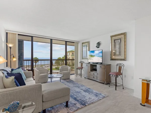 a living room with furniture a rug and a table