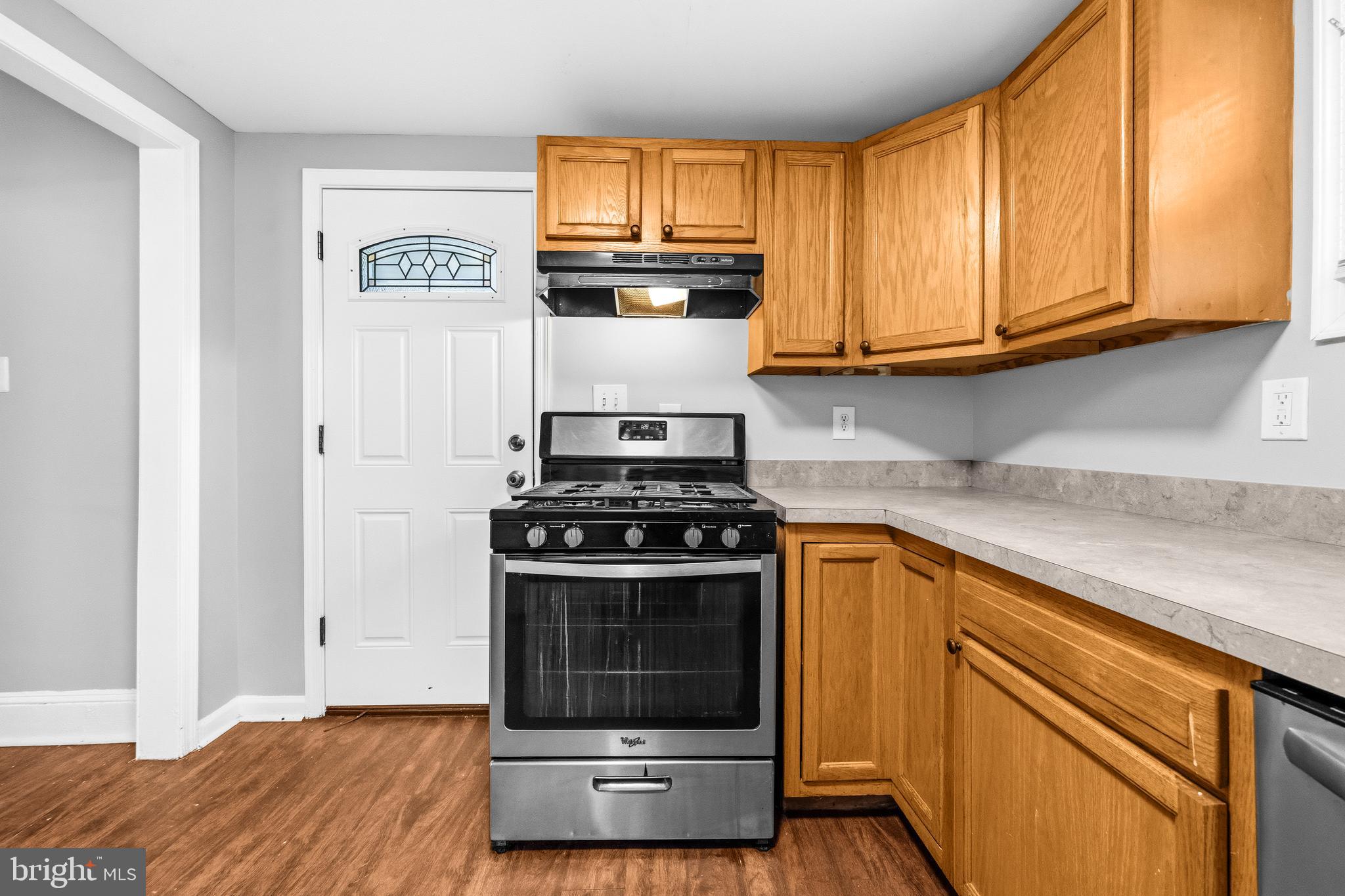 12 Leeway Dundalk, MD 21222 - Photo 16 of 34 a kitchen with granite countertop cabinets stainless steel appliances and wooden floor