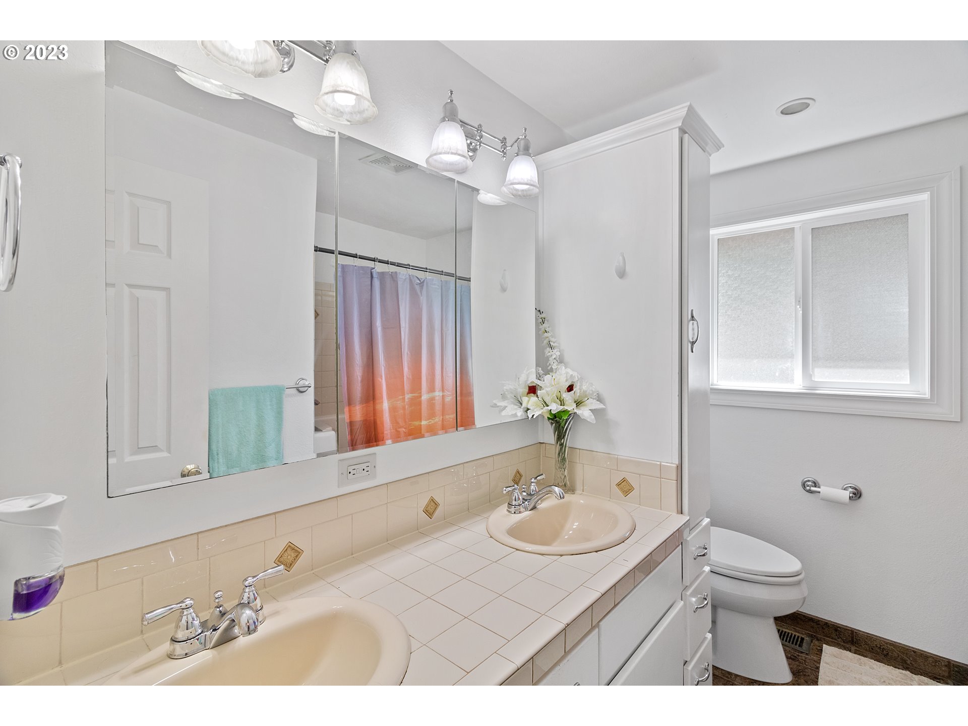 19600 Leland Road Oregon City, OR 97045 - Photo 20 of 34 a bathroom with a granite countertop sink a toilet a mirror and shower
