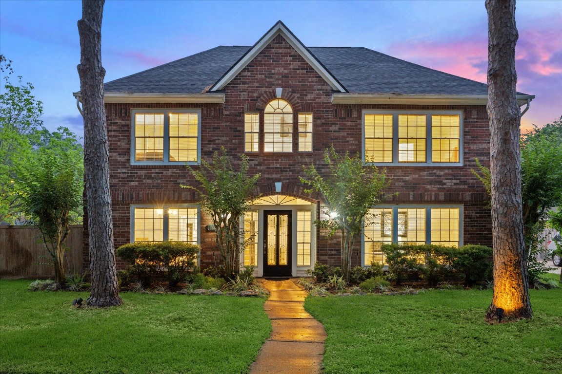 a front view of a house with a yard