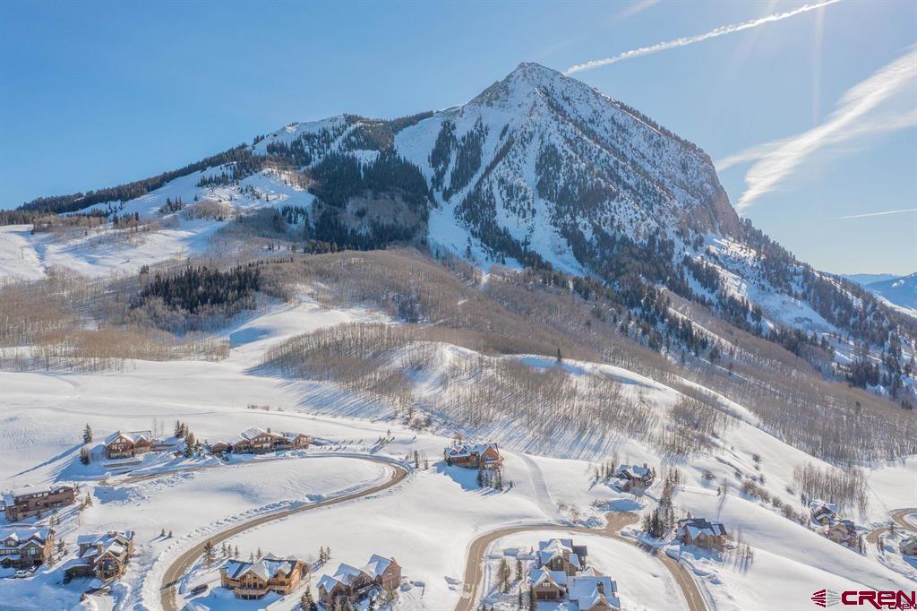 57 Summit Road Crested Butte, CO 81225 - Photo 19 of 22 a bed with white sheets and pillows on it