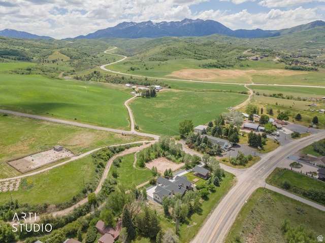 1188 South Old Trappers Loop Road Huntsville, UT 84317 - Photo 85 of 92 Aerial perspective showcasing expansive green fields, established roads, and distant snow-capped mountains