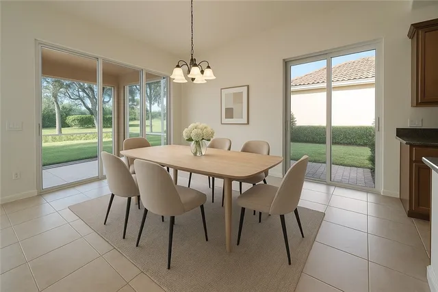 a view of a dining room with furniture a chandelier and wooden floor