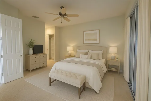a spacious bedroom with a bed and a chandelier