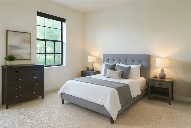 a bedroom with a bed and a window