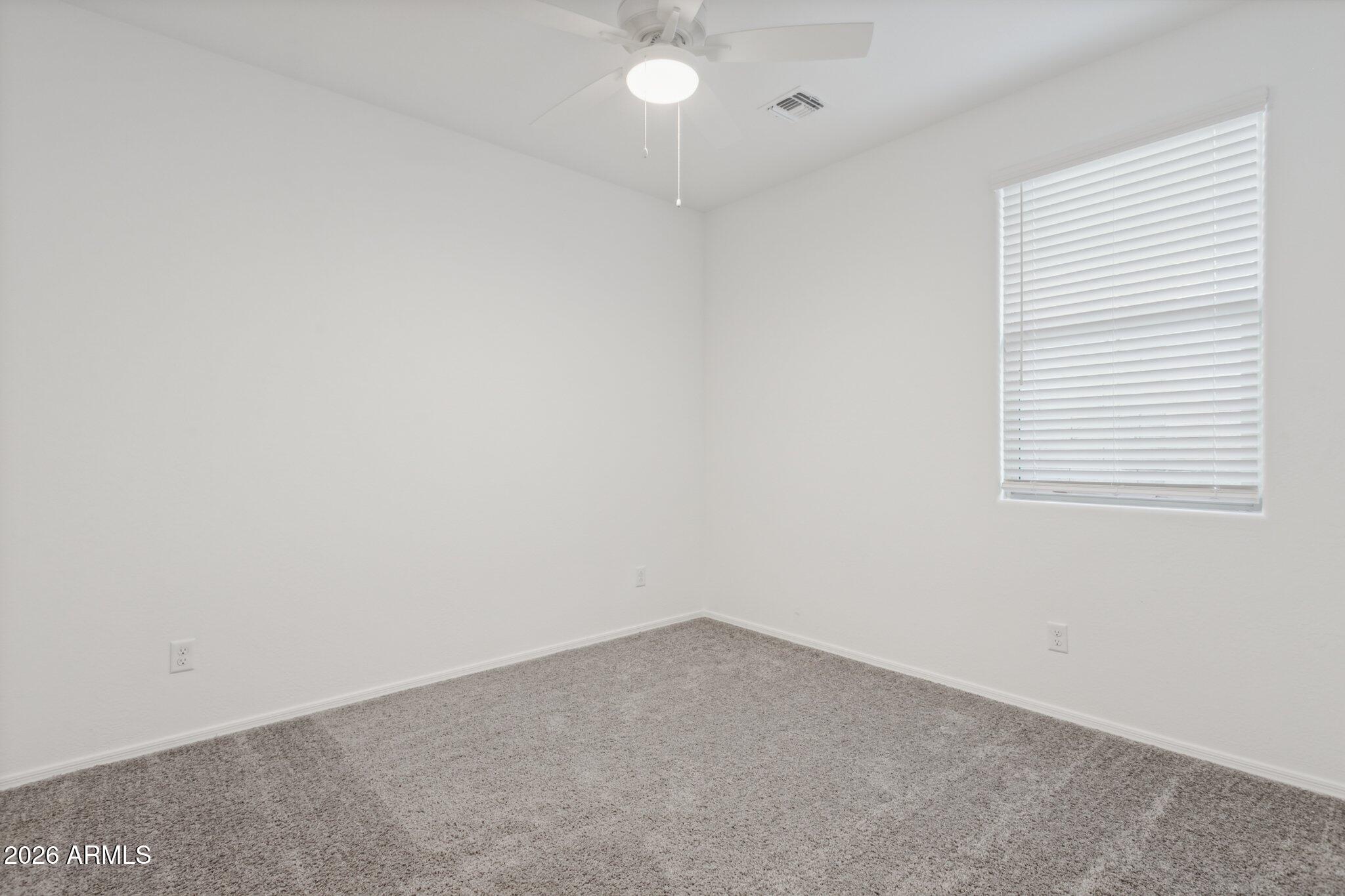 17334 West Wandering Creek Road Goodyear, AZ 85338 - Photo 22 of 67 an empty room with a window