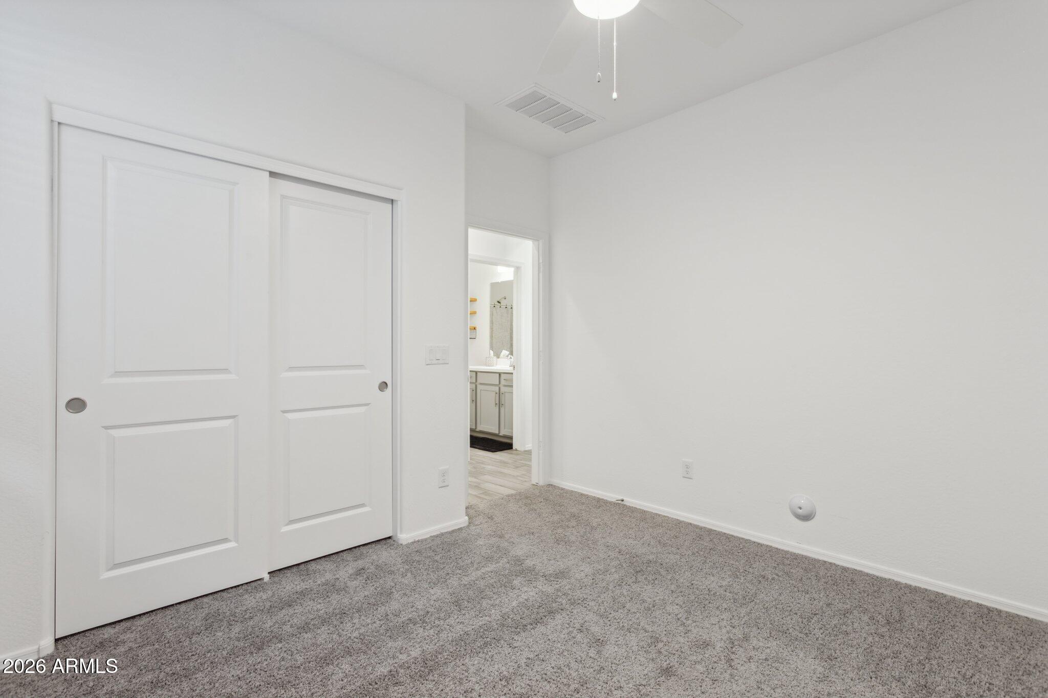 17334 West Wandering Creek Road Goodyear, AZ 85338 - Photo 23 of 67 an empty room with closet area