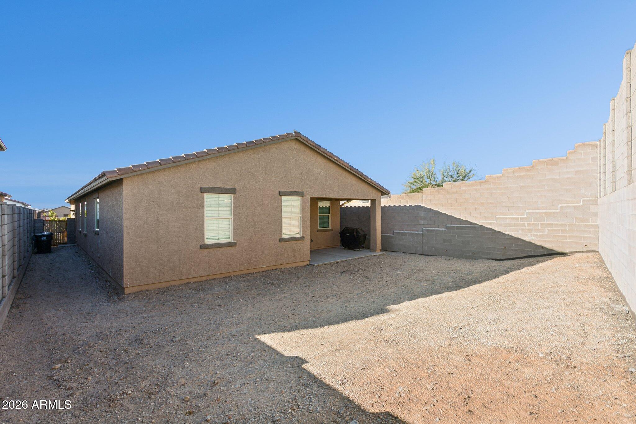 17334 West Wandering Creek Road Goodyear, AZ 85338 - Photo 30 of 67 a view of a house with a backyard