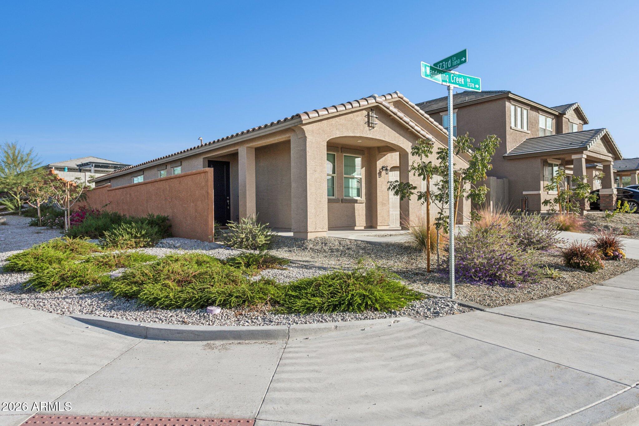 17334 West Wandering Creek Road Goodyear, AZ 85338 - Photo 4 of 67 a front view of a house with a yard