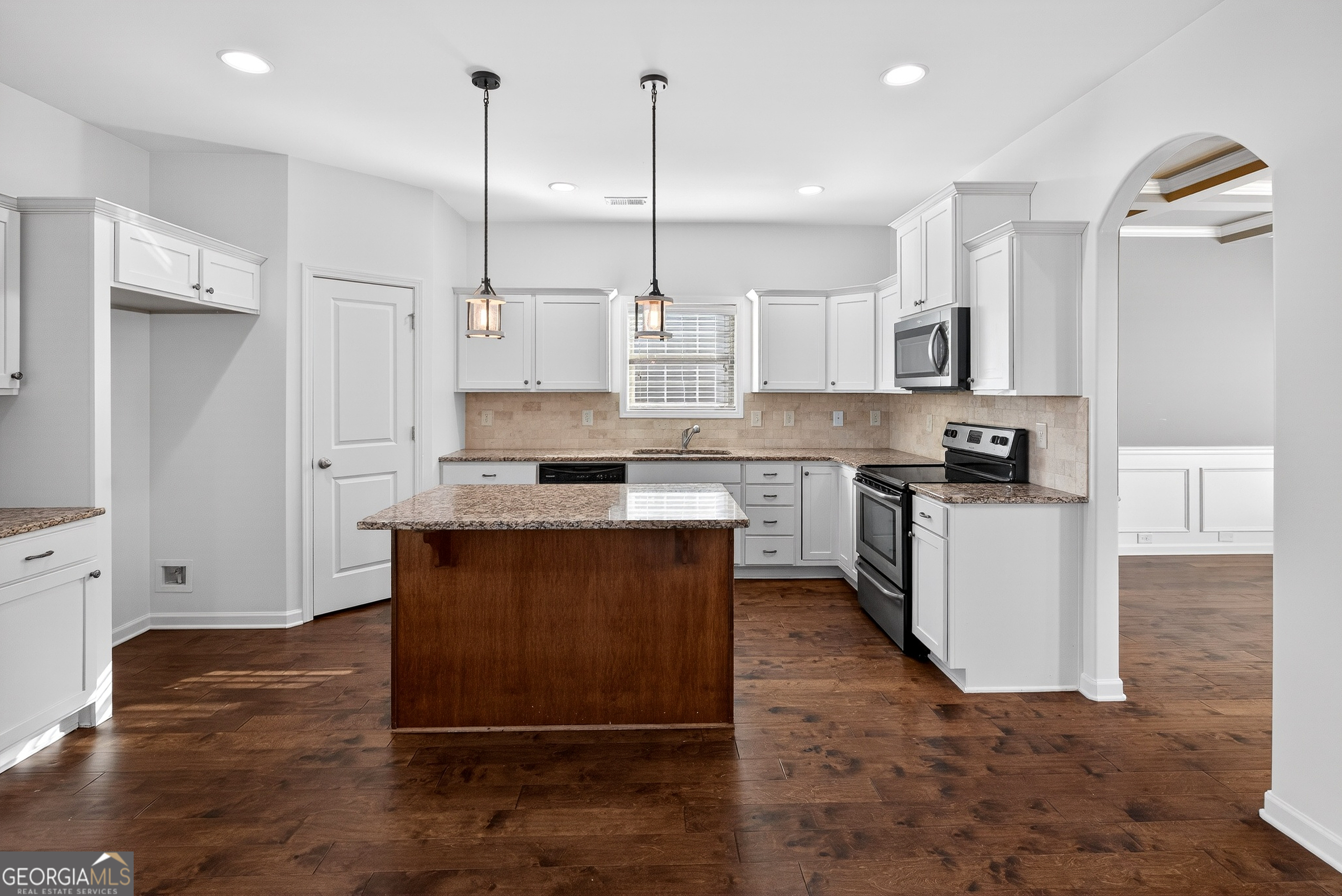 167 Cliffhaven Circle Newnan, GA 30263 - Photo 15 of 47 a kitchen with kitchen island a counter top space a sink and a stove