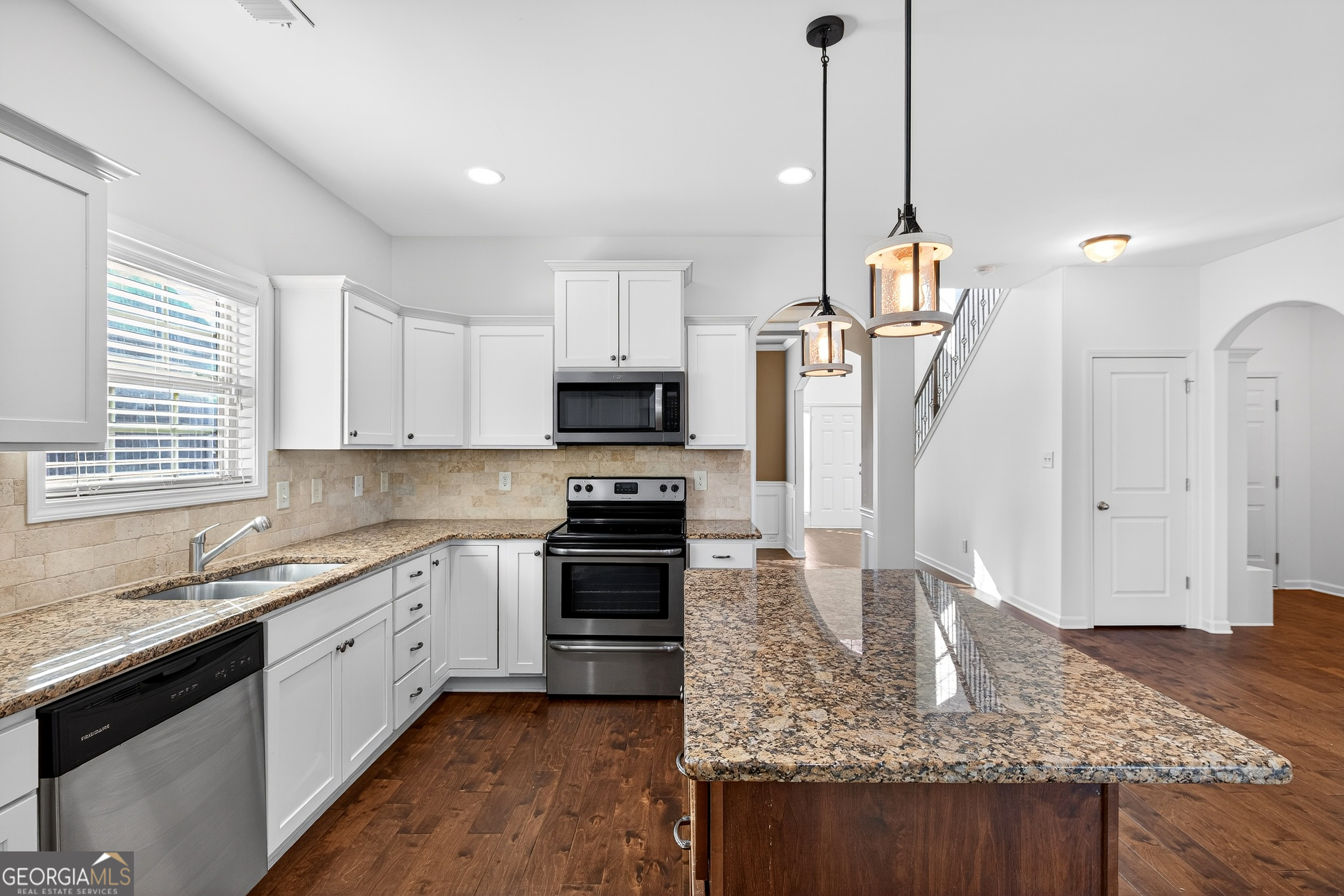 167 Cliffhaven Circle Newnan, GA 30263 - Photo 16 of 47 a kitchen with stainless steel appliances granite countertop a sink a stove and a refrigerator