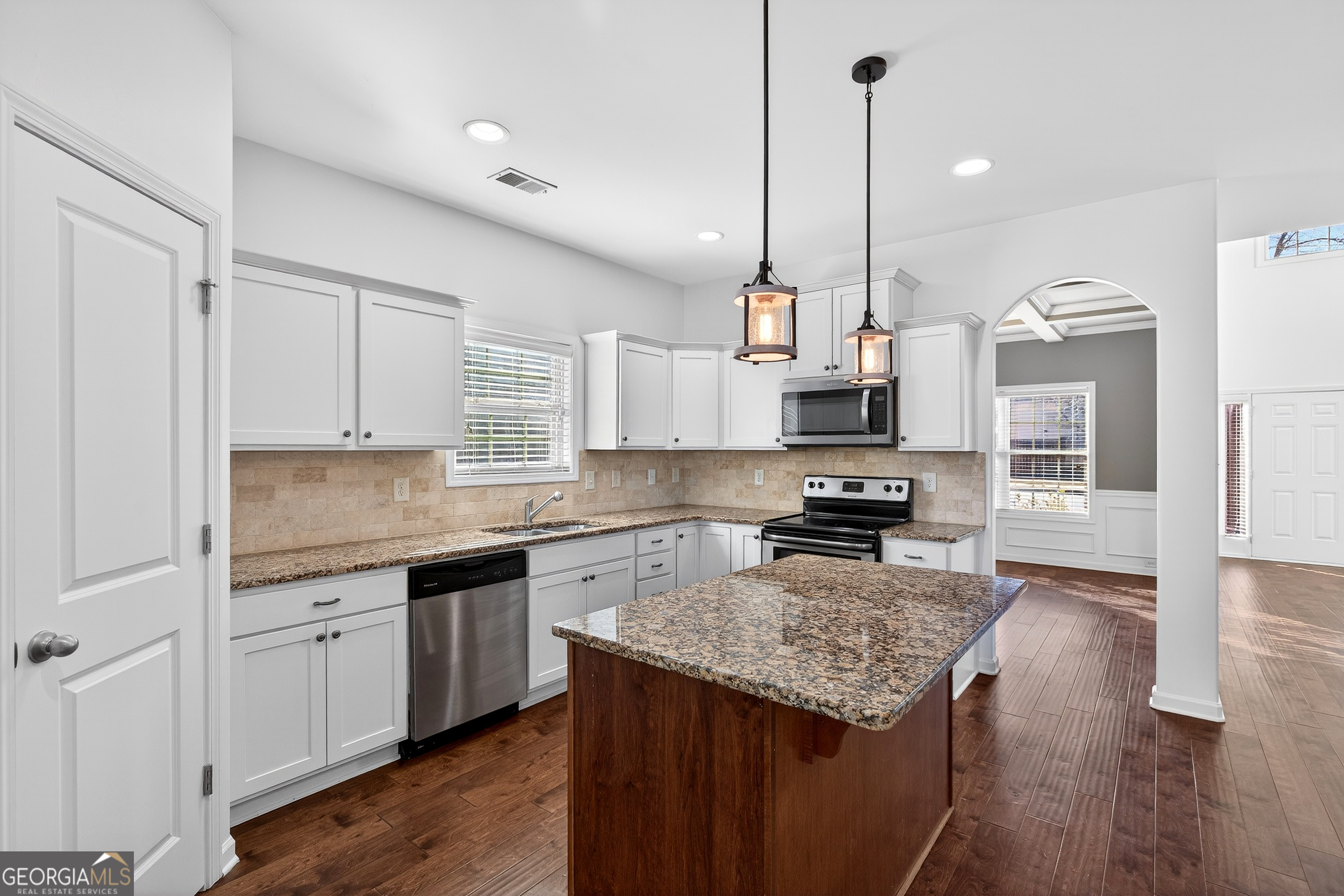 167 Cliffhaven Circle Newnan, GA 30263 - Photo 2 of 47 a kitchen with stainless steel appliances granite countertop a sink a stove and a wooden floors