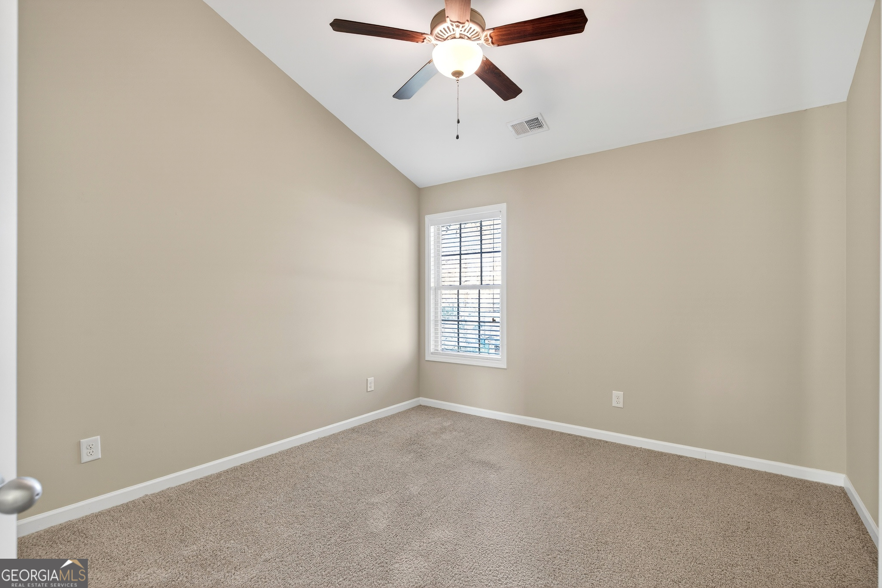 167 Cliffhaven Circle Newnan, GA 30263 - Photo 34 of 47 an empty room with chandelier fan and windows