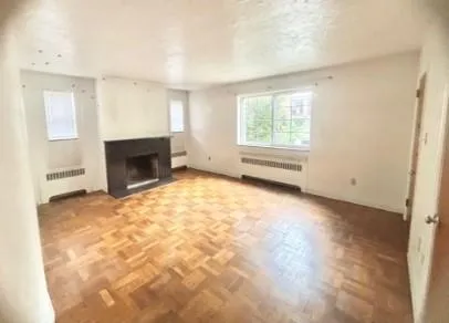 a view of empty room with a fireplace
