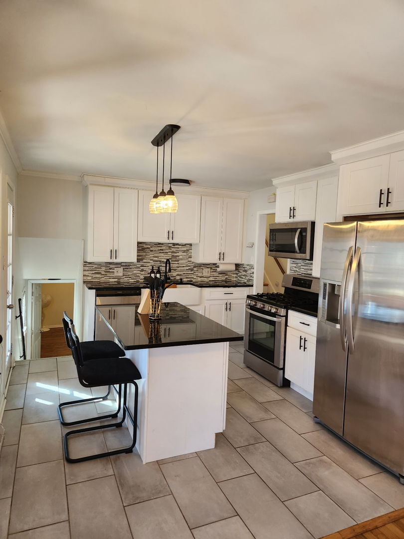 2341 Clyde Terrace Homewood, IL 60430 - Photo 6 of 13 a kitchen with stainless steel appliances kitchen island granite countertop a sink a counter top space cabinets and stainless steel appliances