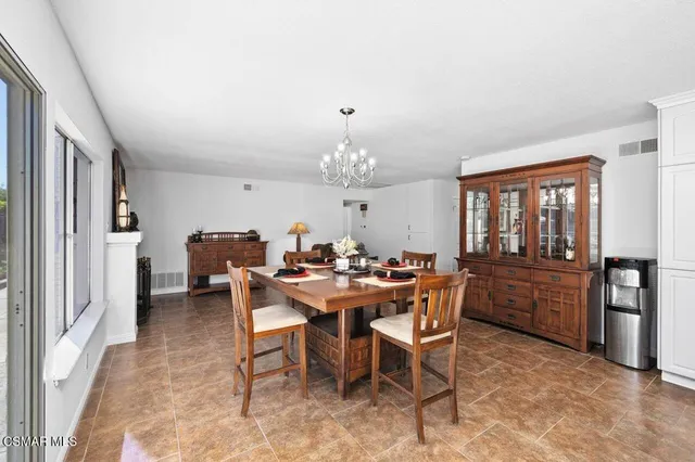 a view of a dining room with furniture and chandelier