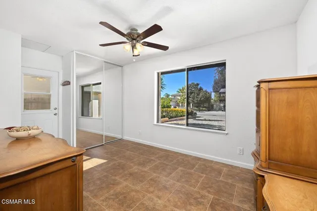 a view of a livingroom with a window and wooden floor