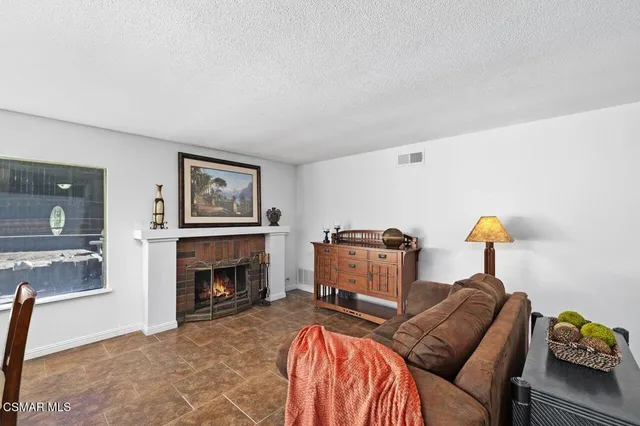 a bedroom with furniture and a fireplace
