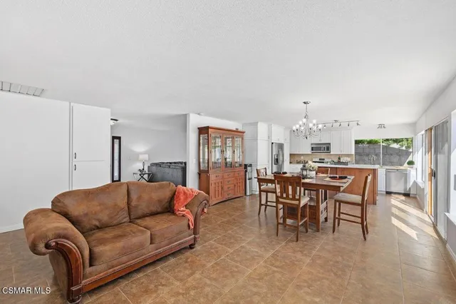 a living room with furniture a dining table and chairs