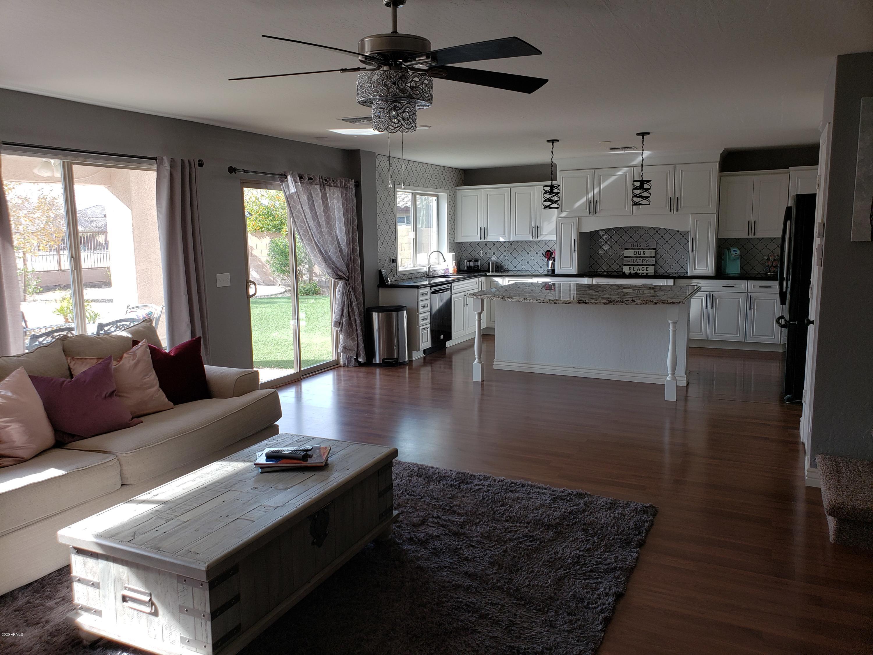 2917 West Fremont Rd. Phoenix, AZ 85041 - Photo 11 of 41 a living room with stainless steel appliances granite countertop furniture wooden floor and a large window