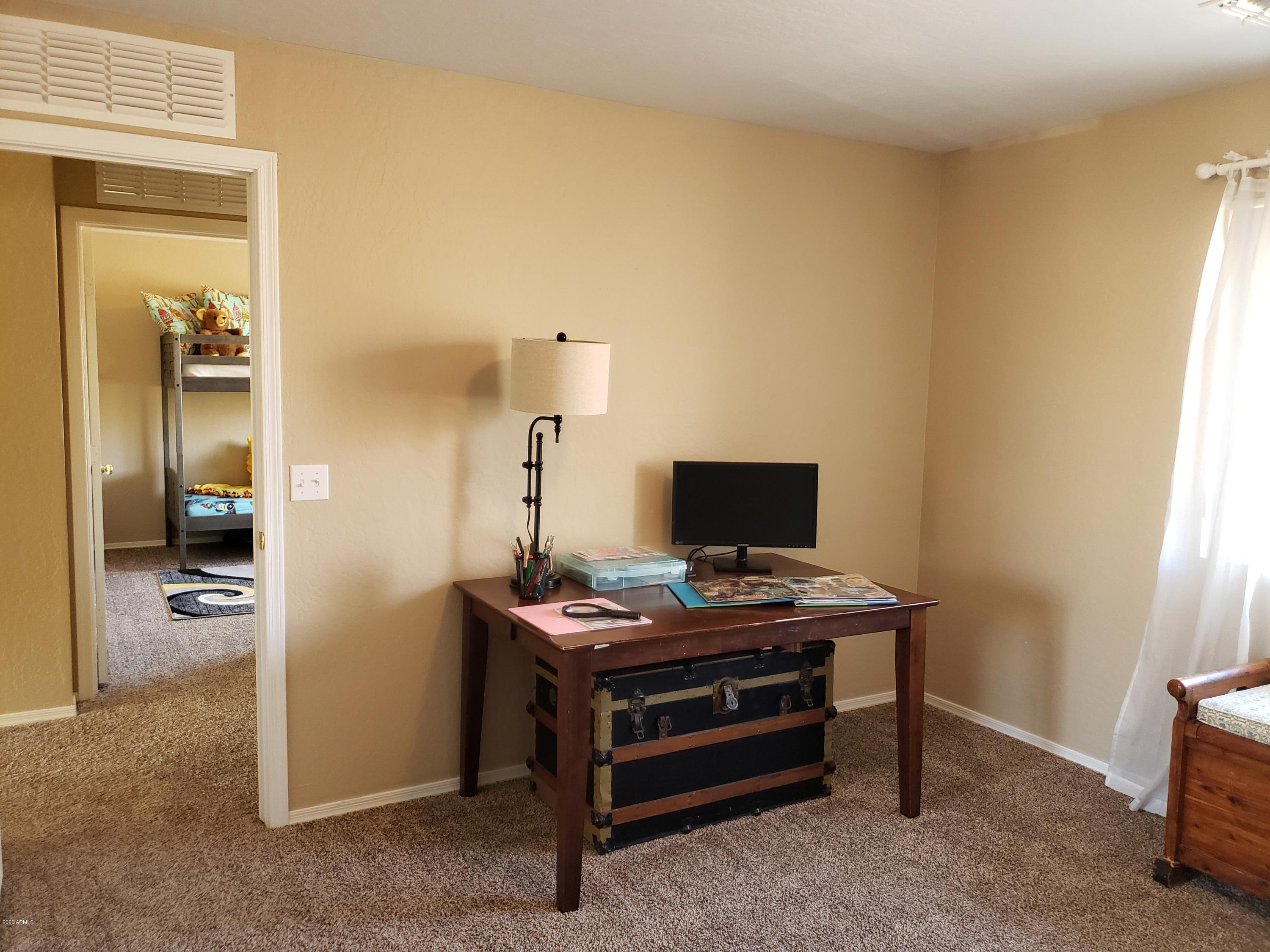 2917 West Fremont Rd. Phoenix, AZ 85041 - Photo 16 of 41 a view of a workspace with furniture and a window