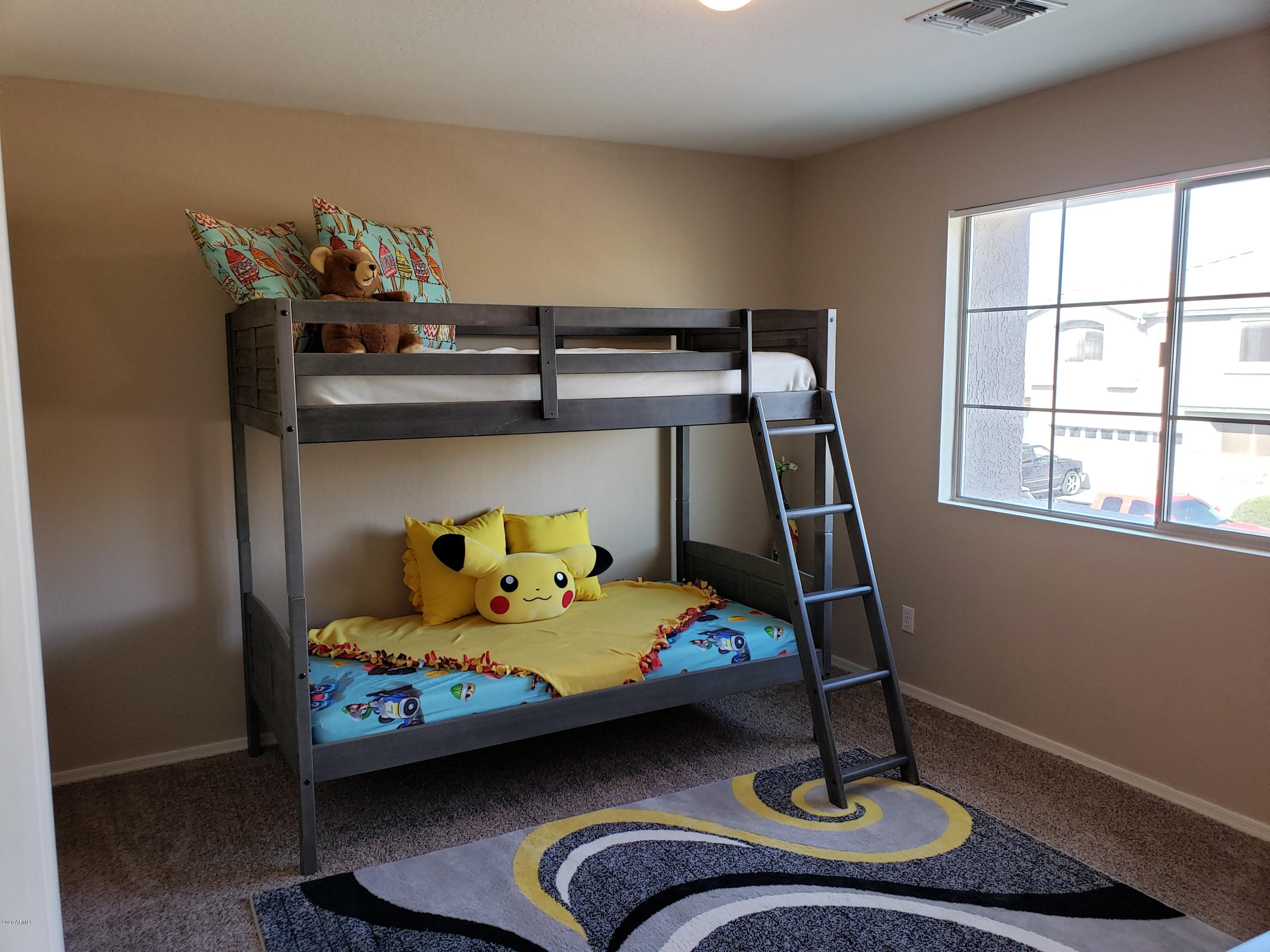 2917 West Fremont Rd. Phoenix, AZ 85041 - Photo 17 of 41 a bedroom with a bunk bed and a window