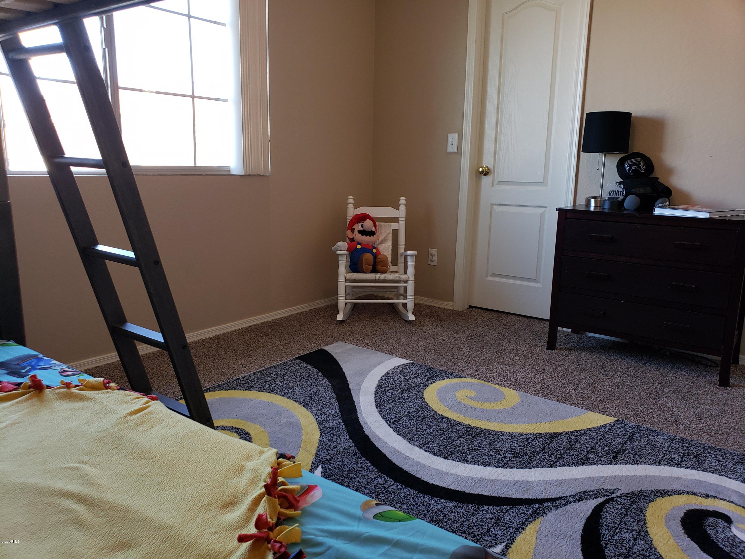2917 West Fremont Rd. Phoenix, AZ 85041 - Photo 18 of 41 a room with furniture and a window