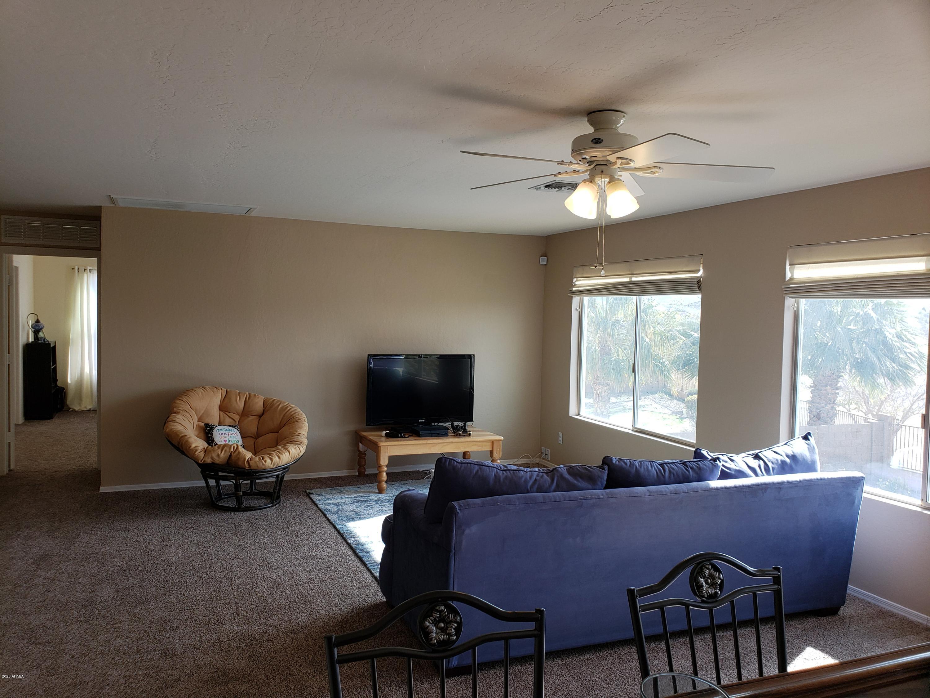 2917 West Fremont Rd. Phoenix, AZ 85041 - Photo 24 of 41 a living room with furniture and a flat screen tv