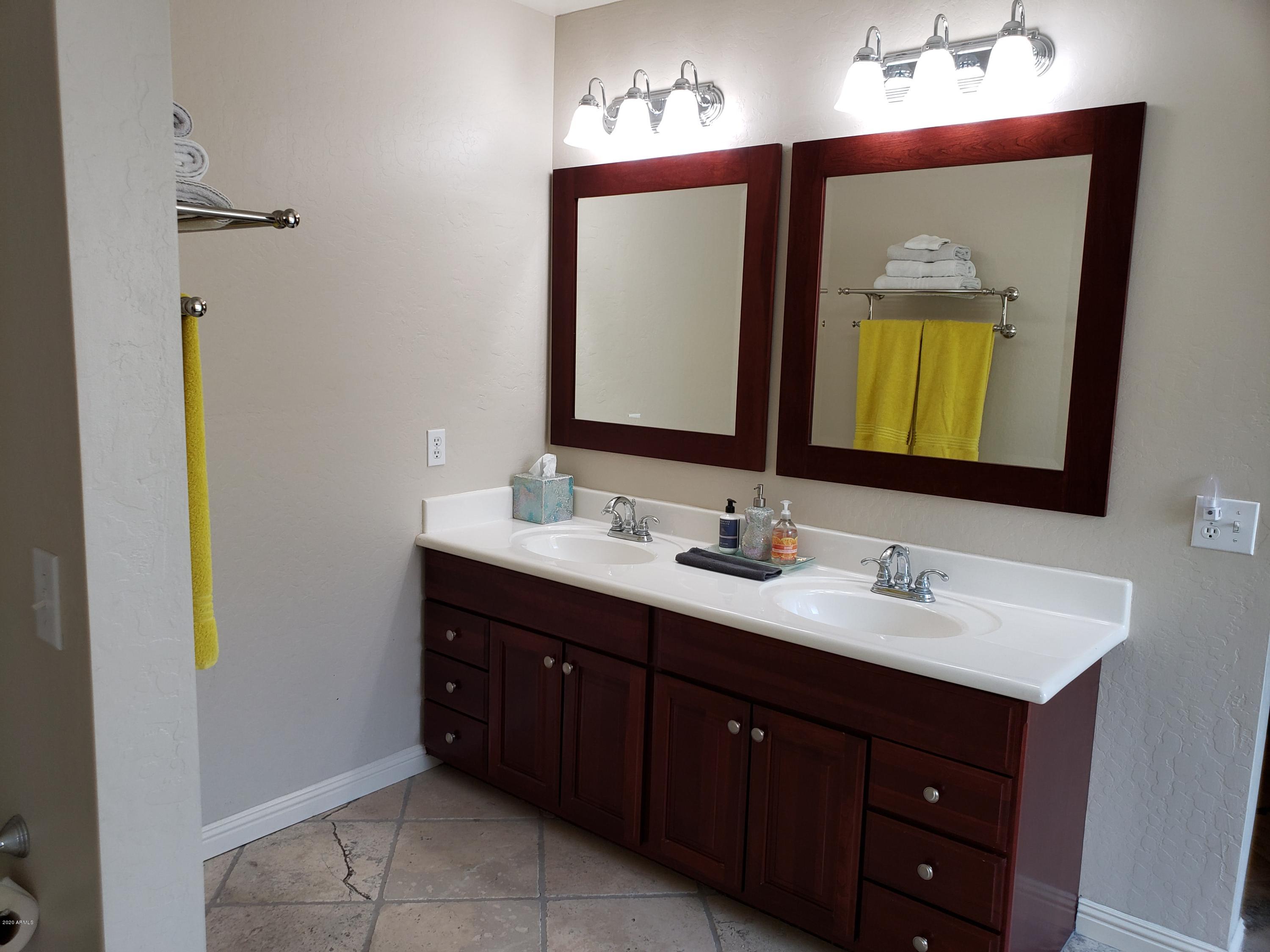 2917 West Fremont Rd. Phoenix, AZ 85041 - Photo 26 of 41 a bathroom with a double vanity sink and a mirror