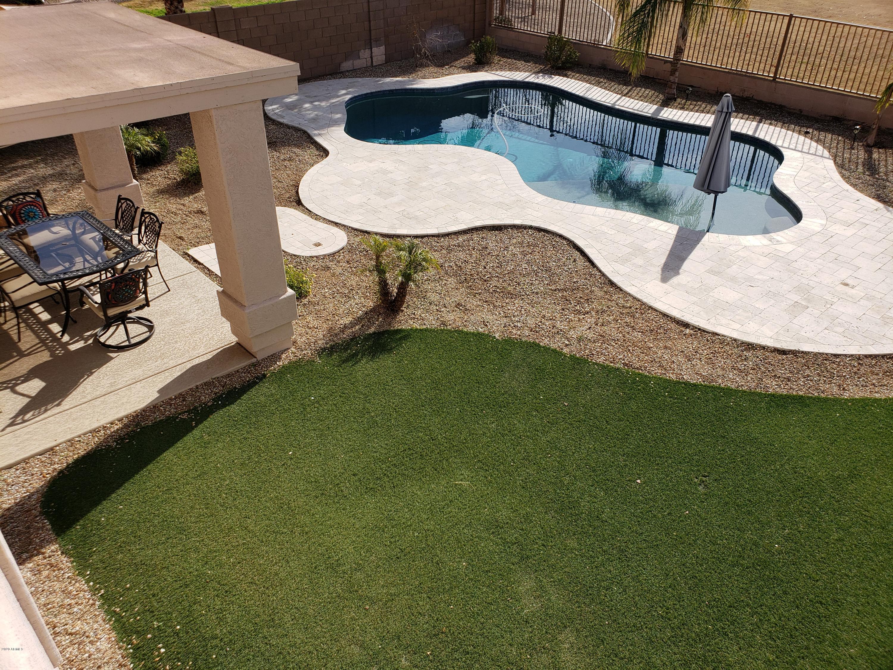 2917 West Fremont Rd. Phoenix, AZ 85041 - Photo 30 of 41 a view of a swimming pool with a yard