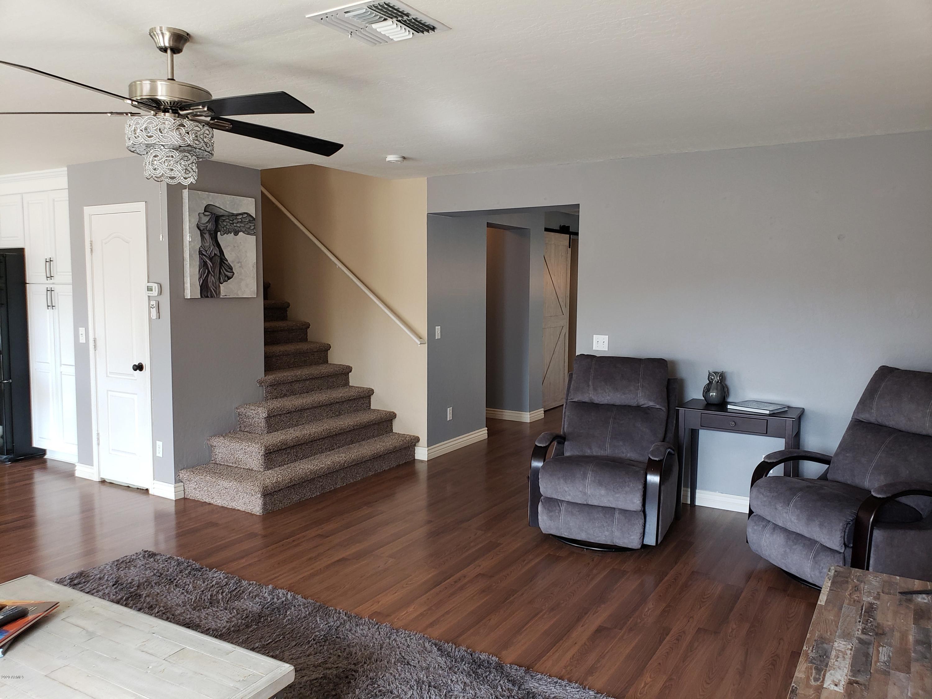 2917 West Fremont Rd. Phoenix, AZ 85041 - Photo 10 of 41 a living room with furniture and a wooden floor