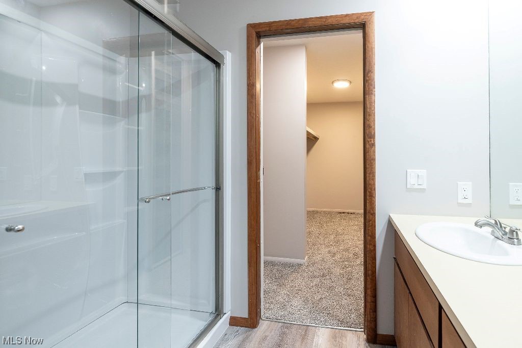 10808 Priem Road Strongsville, OH 44149 - Photo 12 of 26 Bathroom featuring hardwood / wood-style flooring, large vanity, and a shower with shower door