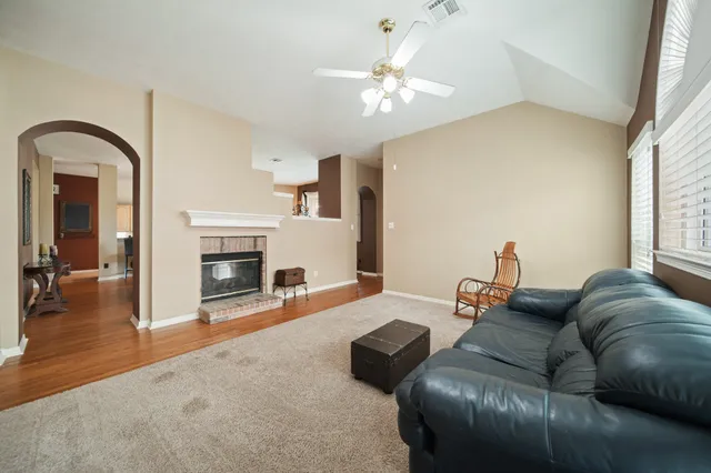 a living room with furniture and a fireplace