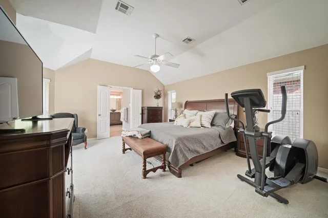 a bedroom with furniture and a window