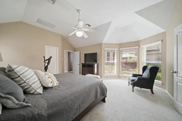 a spacious bedroom with a bed and furniture