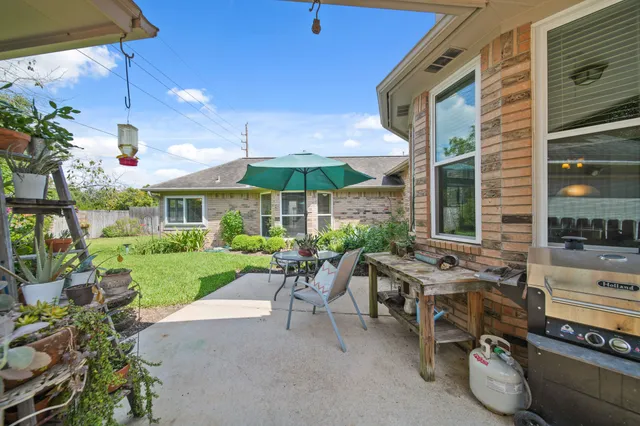 a view of a house with backyard sitting area and garden