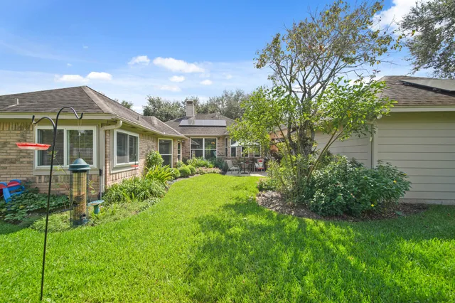 a front view of a house with a yard and potted plants