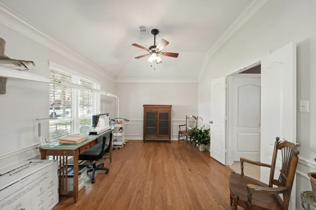 a living room with furniture a window and wooden floor
