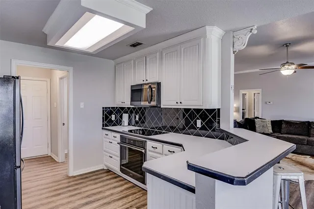 a kitchen with a stove a sink and a refrigerator