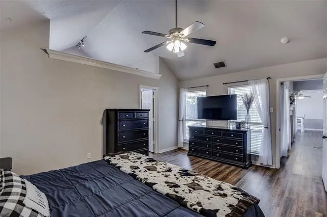 a bedroom with a bed and flat screen tv
