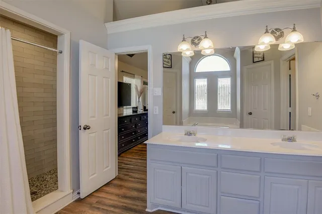 a bathroom with a double vanity sink and a mirror