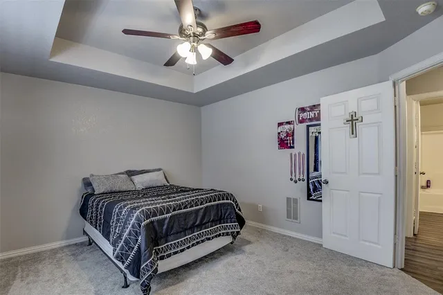 a bedroom with a bed and a ceiling fan