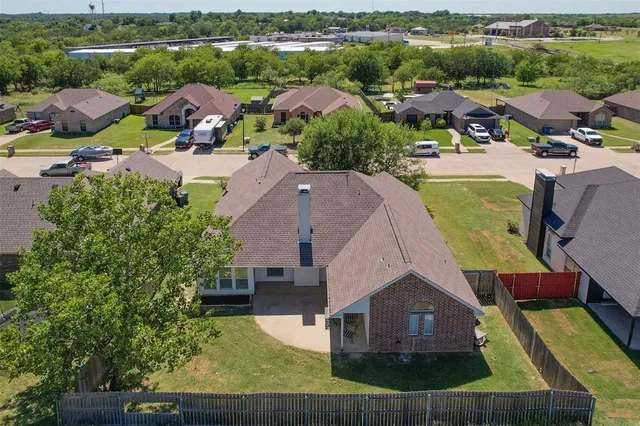 an aerial view of multiple houses with yard
