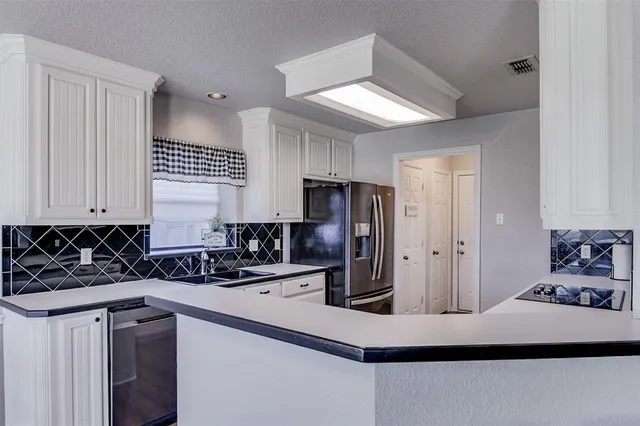 a kitchen with stainless steel appliances a sink stove and refrigerator