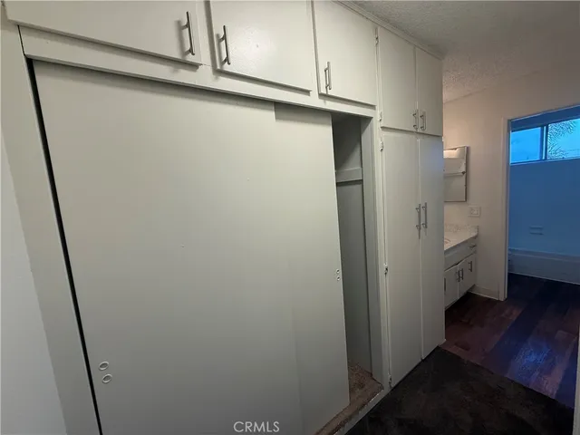 a view of walk in closet with empty racks