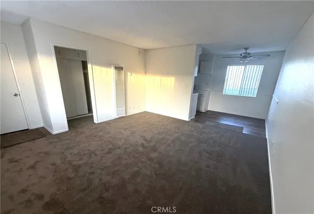 a kitchen with a stove sink and cabinets