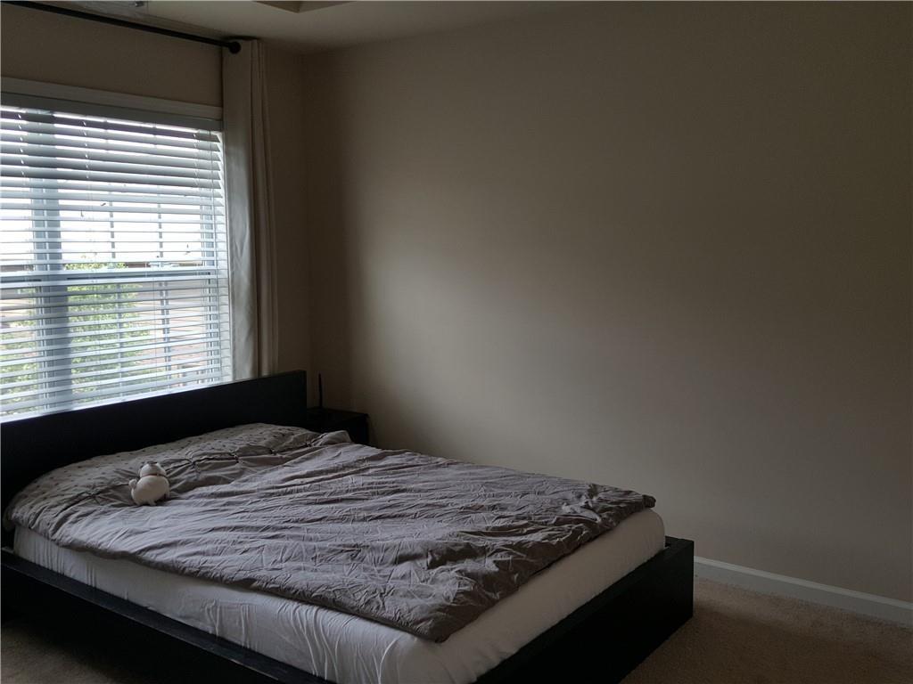 805 Pleasant Hill Road, Unit 330 Lilburn, GA 30047 - Photo 13 of 24 a bed sitting in a bedroom next to a window