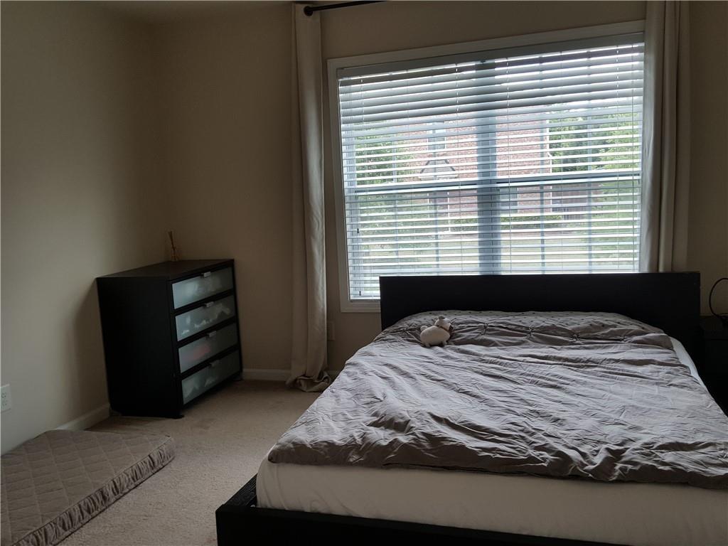 805 Pleasant Hill Road, Unit 330 Lilburn, GA 30047 - Photo 14 of 24 a bedroom with a bed and a window